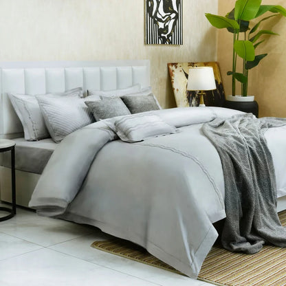 Pearl gray 7-piece duvet cover set with layered duvet cover, shams, and folded throw
