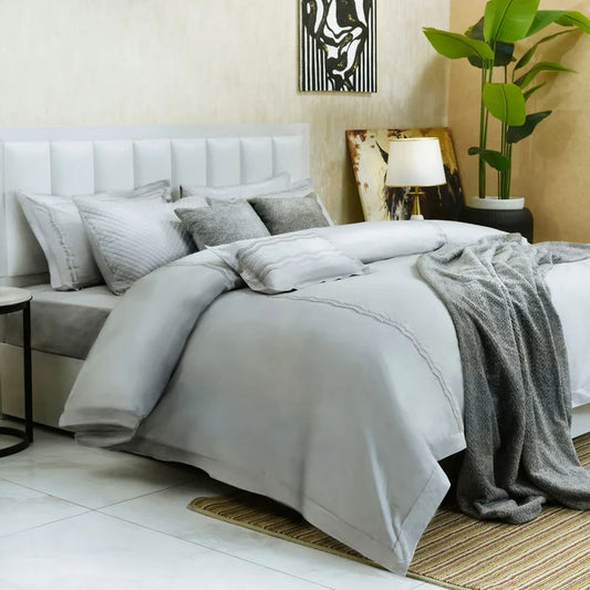 Pearl gray 7-piece duvet cover set with layered duvet cover, shams, and folded throw