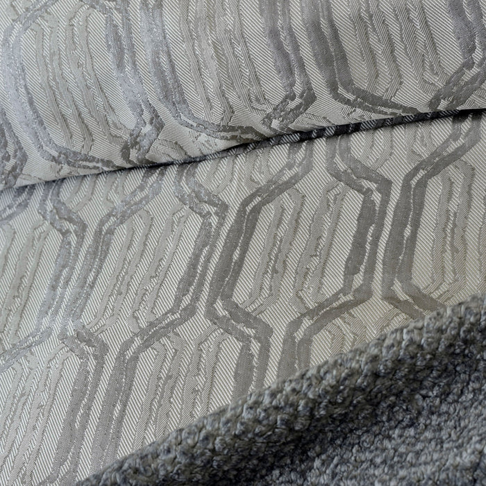 Close-up: charcoal gray duvet cover fabric with woven geometric pattern and seam detail