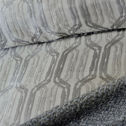Close-up: charcoal gray duvet cover fabric with woven geometric pattern and seam detail