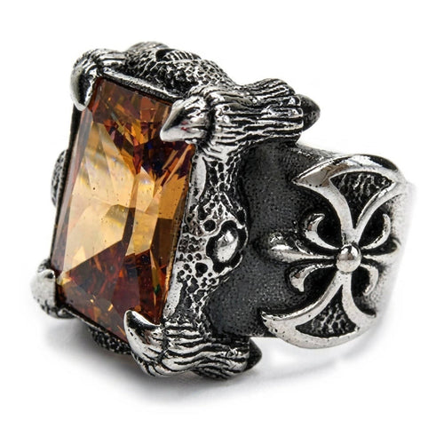 Sterling silver Imperial Topaz dragon claw ring shown three-quarter, golden-orange emerald-cut stone gripped by silver claws