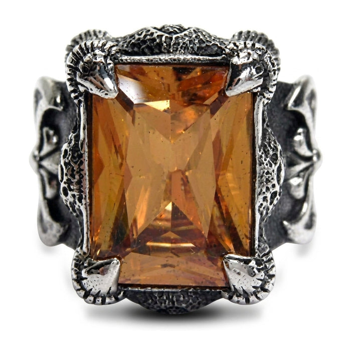 Front view of the rectangular imperial topaz CZ framed by four dragon-claw prongs on an oxidized sterling silver gothic ring