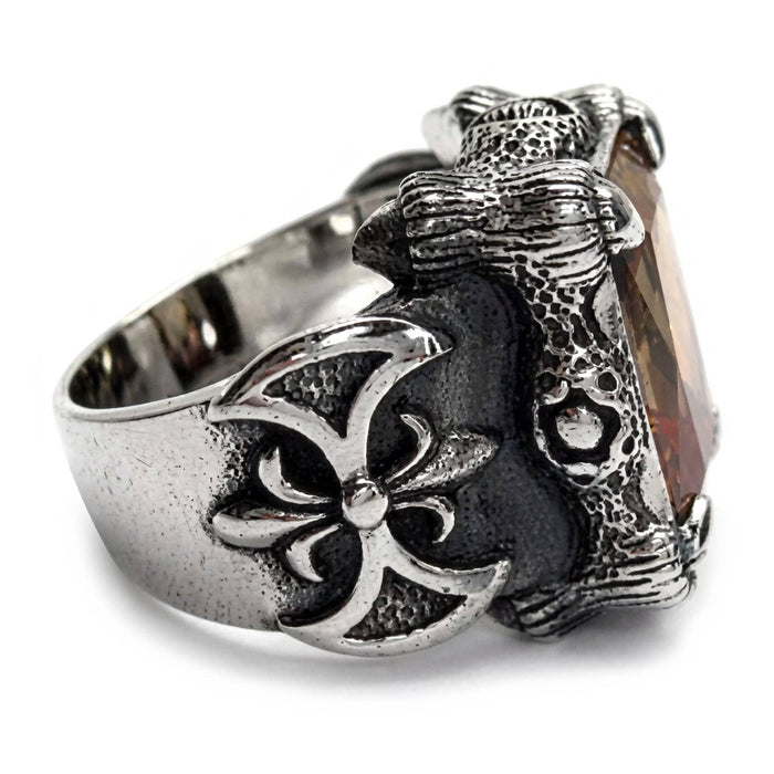 Side profile showing the fleur-de-lis cross shoulder and tapering band of the sterling silver Imperial Topaz claw ring