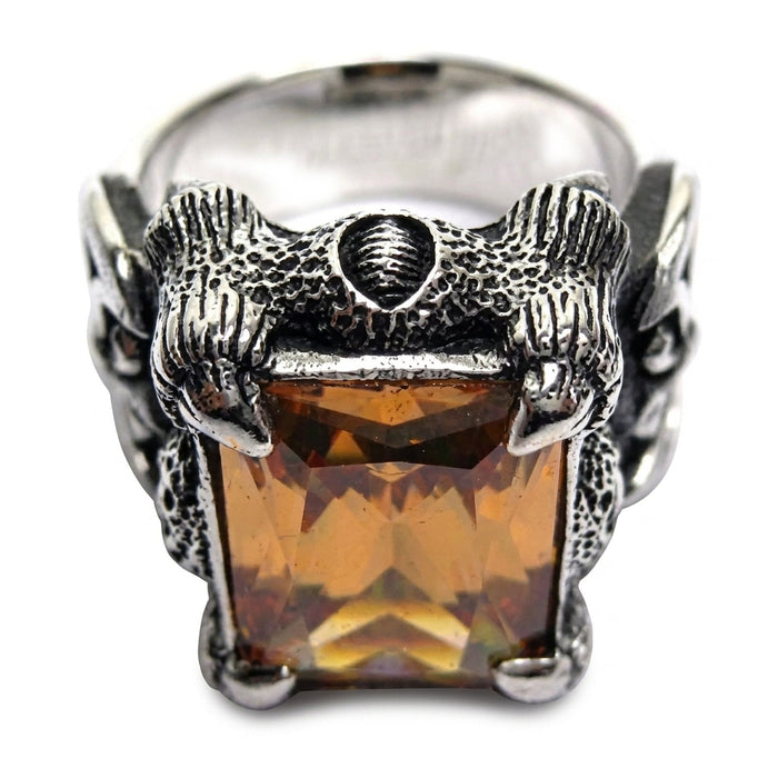 Top-down detail of the twin dragon-head crest and shield above the imperial topaz stone on this sterling silver ring