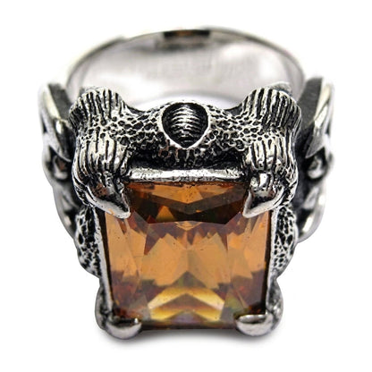 Top-down detail of the twin dragon-head crest and shield above the imperial topaz stone on this sterling silver ring