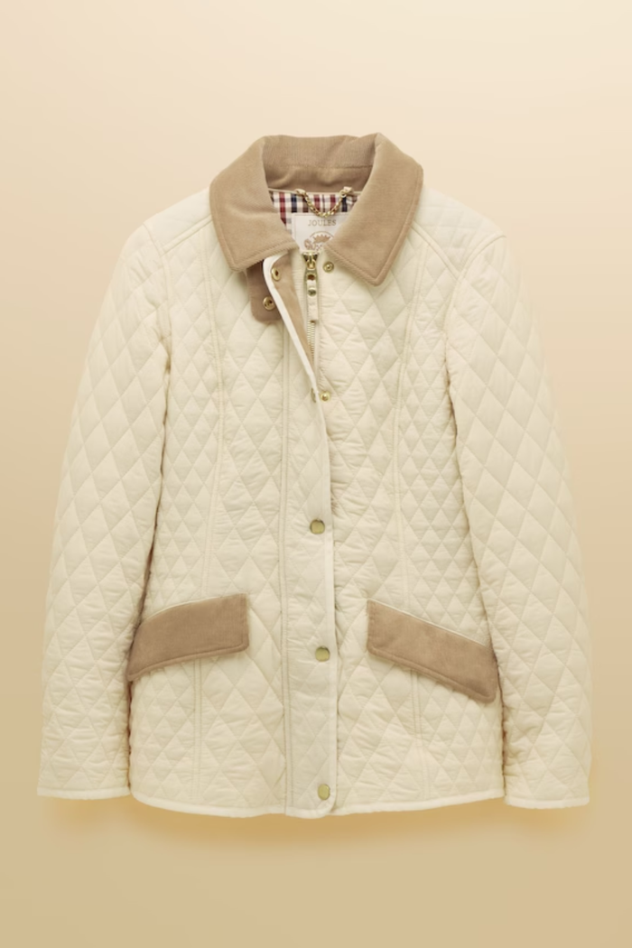 Shop the Joules Highclere showerproof diamond quilted jacket — a stylish and practical layer with cord collar, welt pockets and adjustable waist, perfect for rainy days. Shop Joules at Dotique.