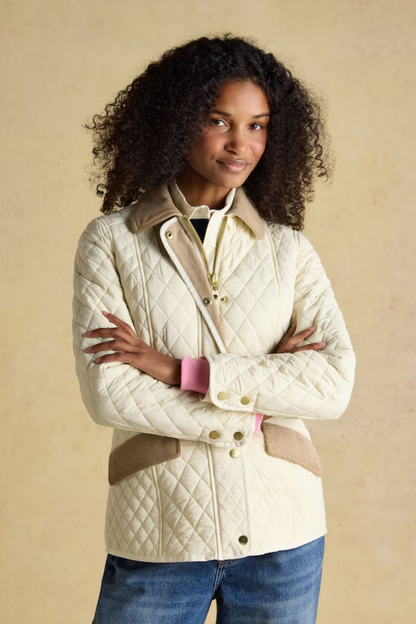 Shop the Joules Highclere showerproof diamond quilted jacket — a stylish and practical layer with cord collar, welt pockets and adjustable waist, perfect for rainy days. Shop Joules at Dotique.