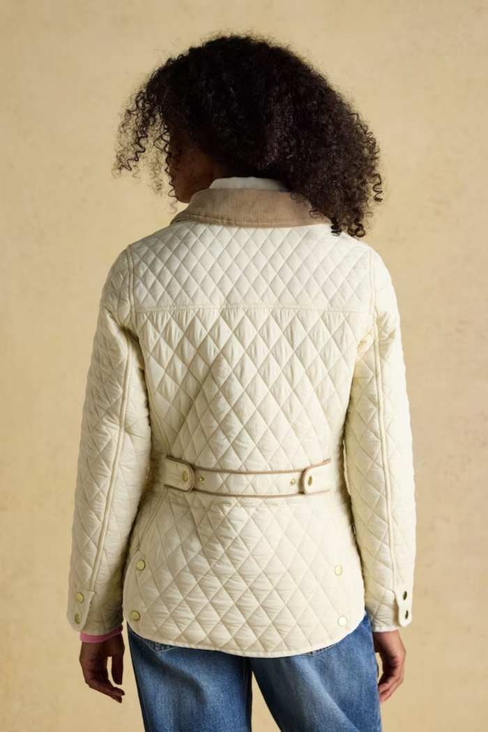 Shop the Joules Highclere showerproof diamond quilted jacket — a stylish and practical layer with cord collar, welt pockets and adjustable waist, perfect for rainy days. Shop Joules at Dotique.