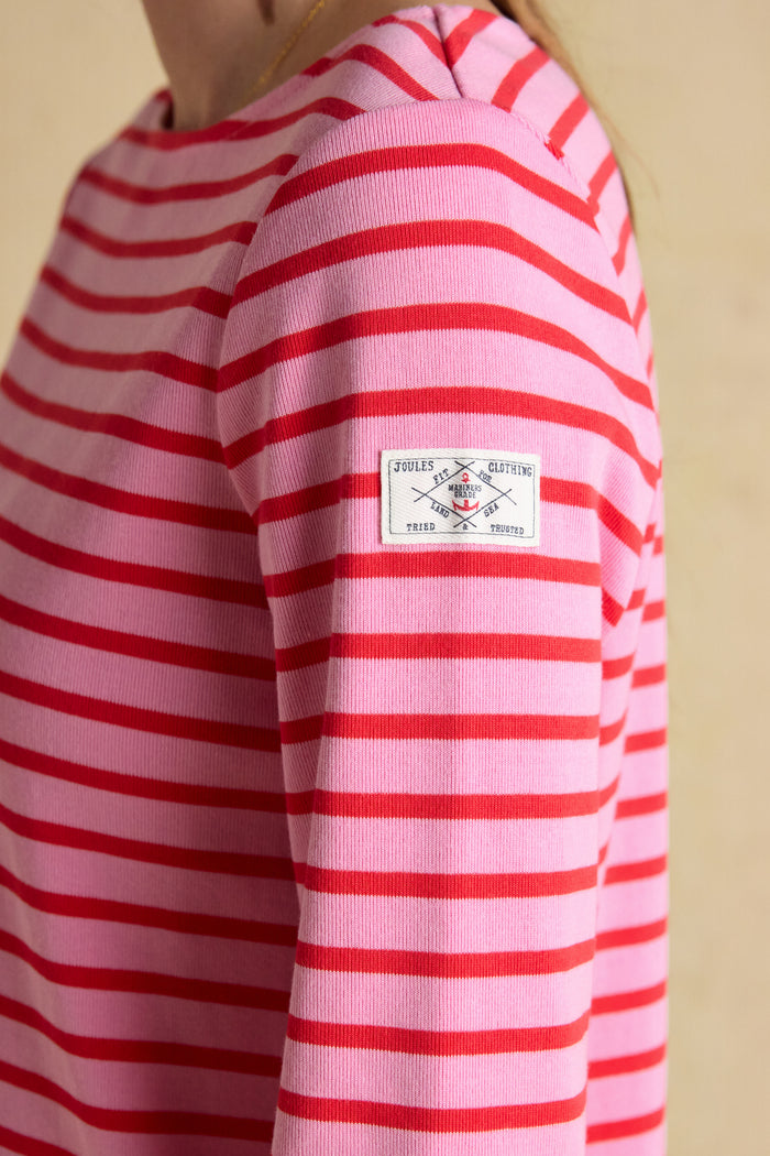 A timeless classic with a fresh pop of colour, the Joules Harbour Breton top in pink and red stripe is one of those pieces that never dates. Shop Joules at Dotique.