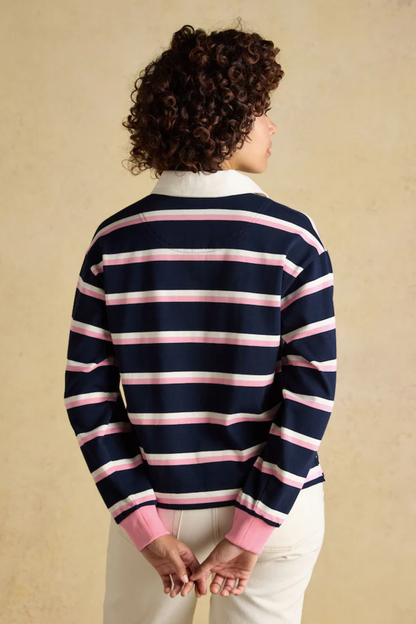 Model wearing Joules W30854 Lara Rugby Shirt – Navy / Pink Stripe by Joules, shop Joules at Dotique.
