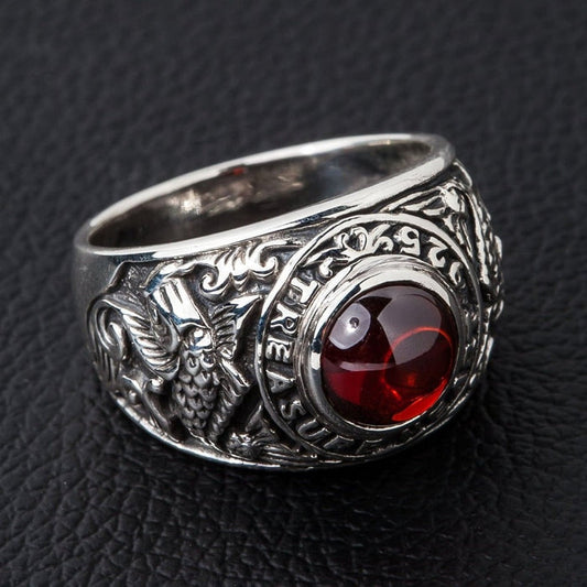 Koi fish sterling silver ring with red cabochon stone front view on black leather