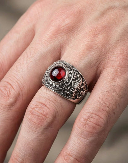 Man wearing koi fish sterling silver ring with red stone on finger