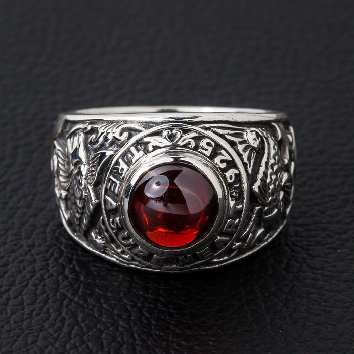 Top view of sterling silver koi fish ring with deep red cabochon centerpiece