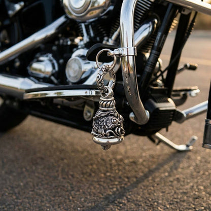Koi Guardian Bell in oxidized sterling silver, hung by a split ring from a cruiser's lower engine guard
