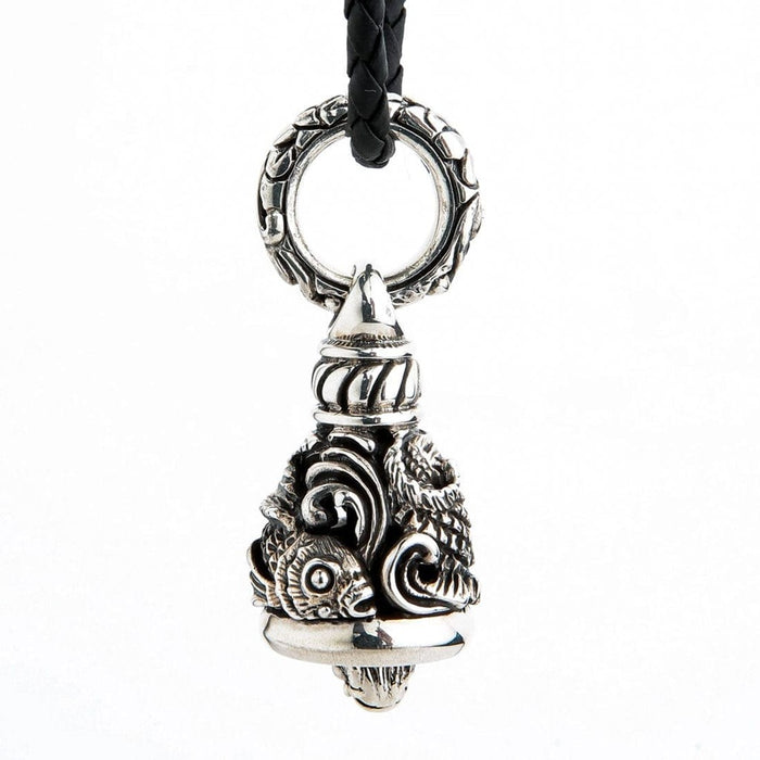 Side view of sterling silver Koi Guardian Bell showing ornate bail and fish tail carving