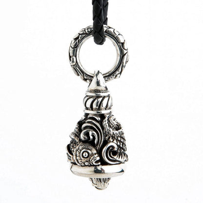 Side view of sterling silver Koi Guardian Bell showing ornate bail and fish tail carving