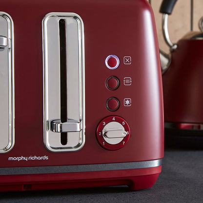 Red toaster with control panel and Morphy Richards branding on a dark surface.
