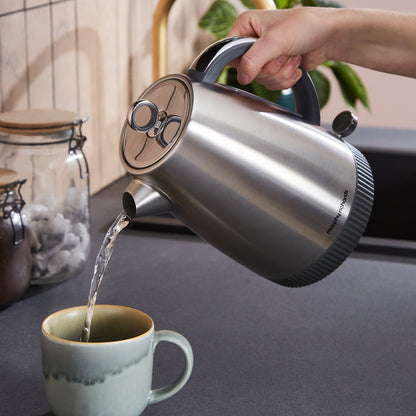 jug kettle pouring hot water into a cup