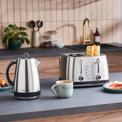Kitchen scene with a kettle, toaster, and coffee on a countertop.