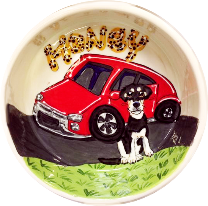 photo of black and white mix breed dog with red car on ceramic dog bowl