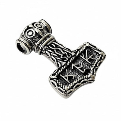 An angled view of the sterling silver owl runic Mjolnir pendant, showing the detailed owl face.