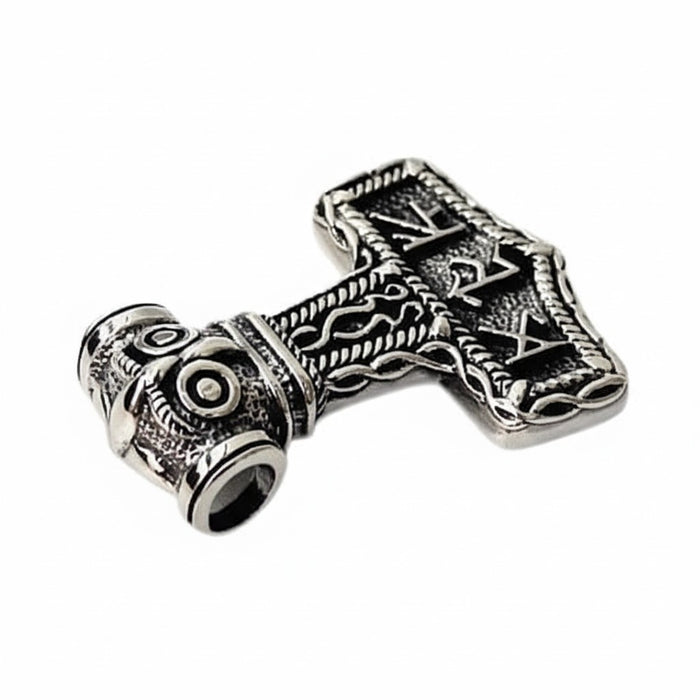 A tilted view of the Mjolnir pendant, showing the open tube bail through the owl's head.
