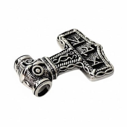 A tilted view of the Mjolnir pendant, showing the open tube bail through the owl's head.