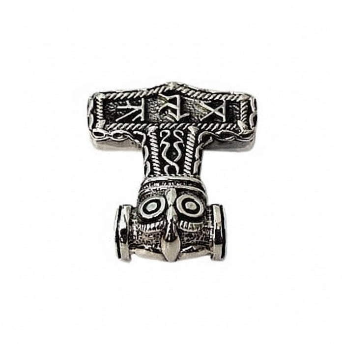 A close view of the owl's round eyes and pointed beak on the runic Mjolnir pendant.