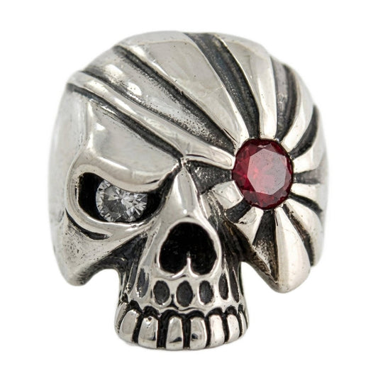 Front view of the Pirate Sterling Silver Skull Ring showcasing mismatched red garnet and clear CZ eyes.