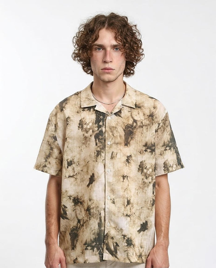 Man wearing a patterned shirt on a white background