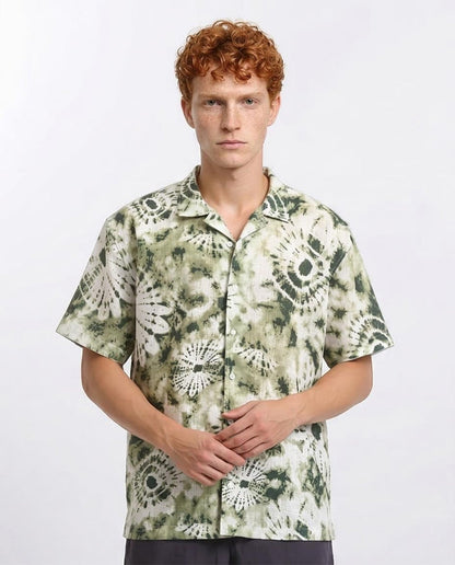 Man wearing a patterned shirt on a white background