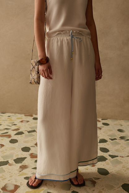 Wide leg cupro trousers by Sancia with elasticated waist and drawstring detail. Lightweight, fluid and easy to style. Shop at Dotique.
