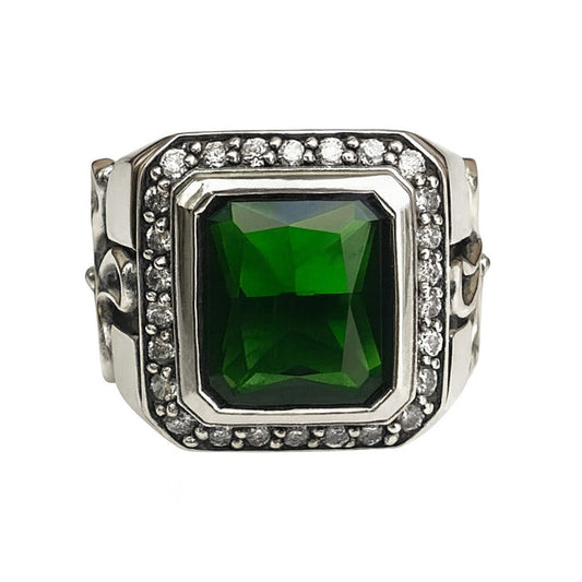 A men's solid sterling silver gothic cross ring, featuring a large green emerald CZ stone and a halo of clear accents.