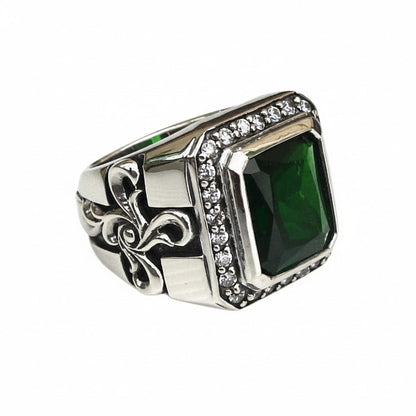 A large emerald CZ ring for men in a sterling silver gothic setting with a brilliant stone halo.