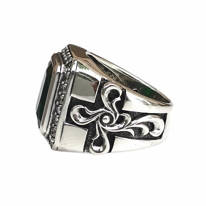 Beaded edging runs under the green stone while raised scrollwork darkens into the sides of the chunky band.