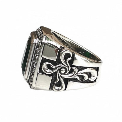 Beaded edging runs under the green stone while raised scrollwork darkens into the sides of the chunky band.