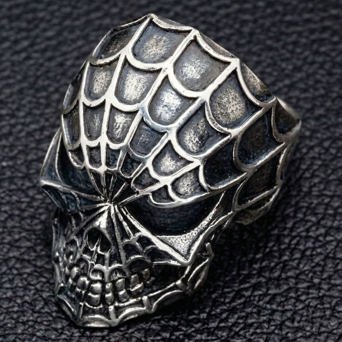 Top down view of gothic spider web pattern on silver ring