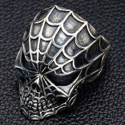 Top down view of gothic spider web pattern on silver ring