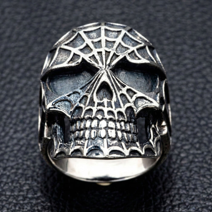 Face on view of men's biker skull ring with intricate carving