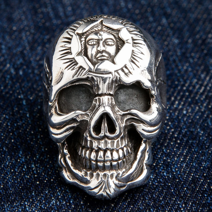A close-up front view of the sun god skull ring, focusing on the intricate emblem carved into the forehead.