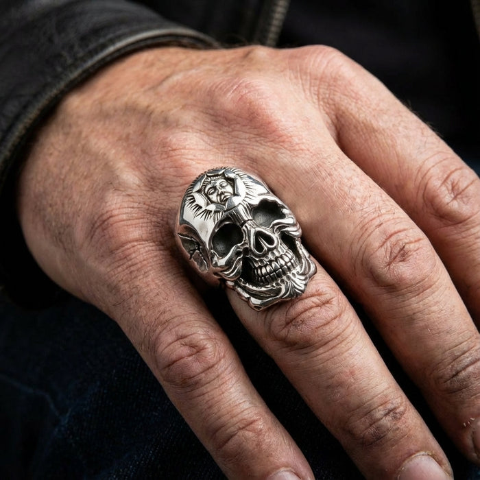 A man wearing the large, heavy sun god skull ring as a statement piece on his finger.