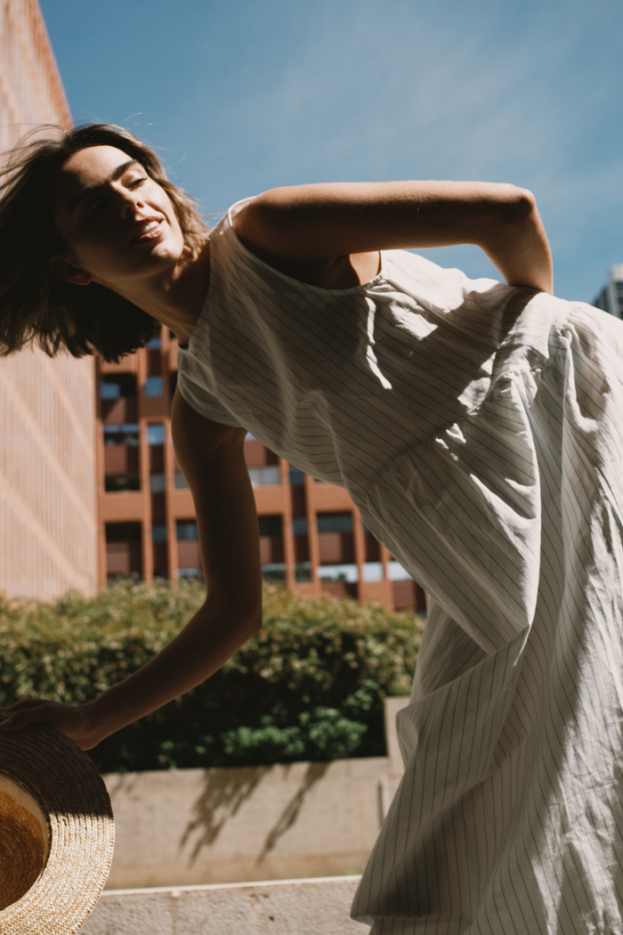 Tiny Big Sister striped cotton dress with a low back detail and relaxed summer fit. Light, flattering and easy to wear. Shop at Dotique.