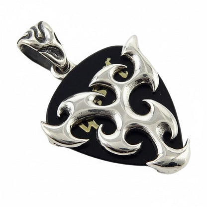 The men's tribal flame pendant shown holding a black guitar pick on a leather necklace.