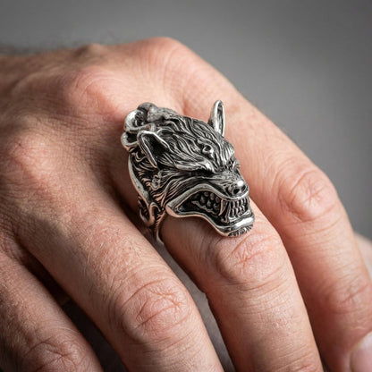 A hand wearing the handcrafted 30-gram werewolf ring to demonstrate its large scale and bold statement.