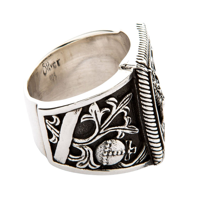 A detailed side view of the winged lion ring, showing the intricate gothic engravings on the band.